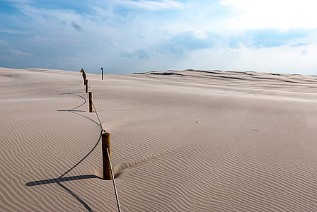 brown fence on desert at daytime thumbnail