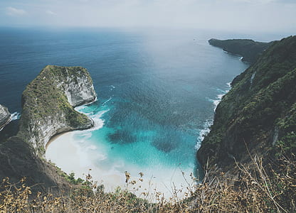 aerial view of blue ocean between cliffs thumbnail