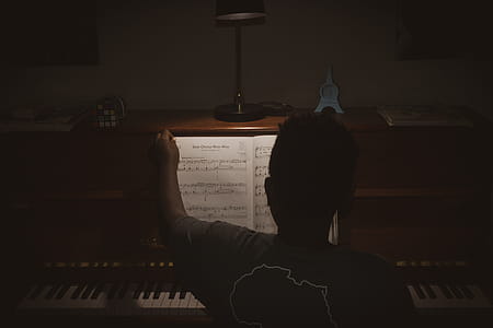 Photo of Person Sitting In Front Of Piano thumbnail