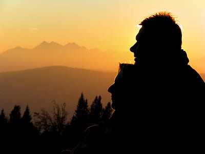 silhouette of man and woman near mountain thumbnail