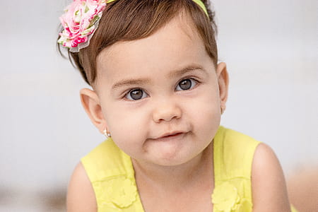 baby girl wearing yellow dress in close-up photo thumbnail