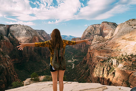 woman shouting on the edge of mountain view thumbnail