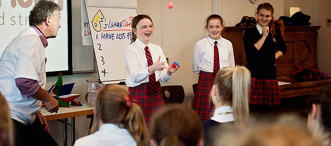 girl in school uniform performing in class at daytime thumbnail