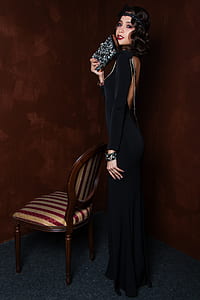 woman standing in front of chair thumbnail
