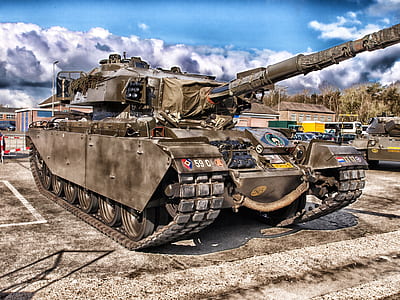 close-up photography of battle tank near trees thumbnail