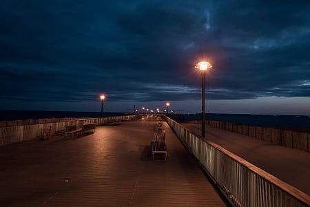 empty bridge with lamp posts during nighttime photo thumbnail