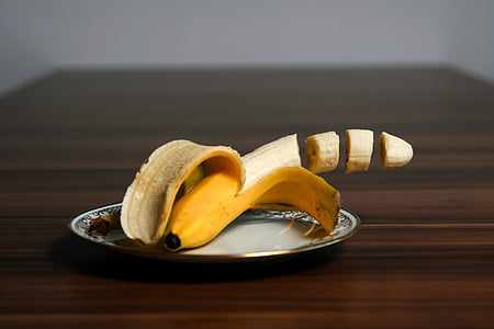 ripe banana on white ceramic saucer thumbnail