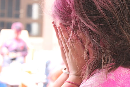 woman covering her face with both hands thumbnail