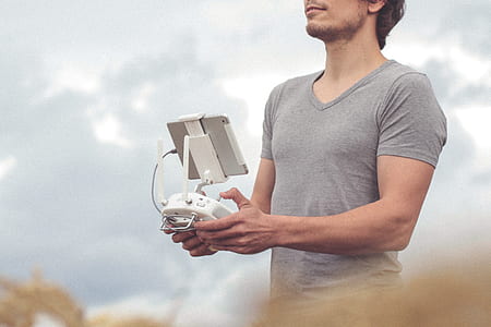man holding white quadcopter controller thumbnail