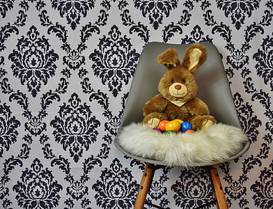 brown bear plush toy on gray leather chair thumbnail