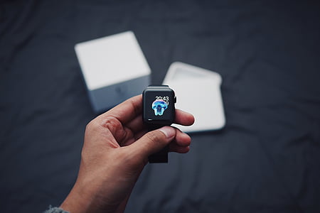person holding space black Apple watch thumbnail