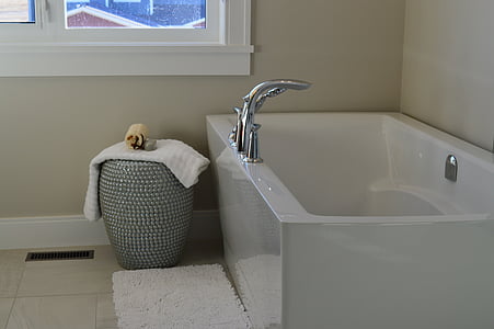white fleece towel beside white bathtub thumbnail