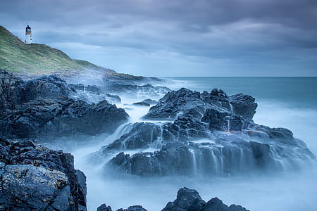 stone formation near body of water thumbnail
