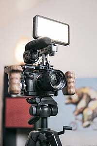 black Sony DLSR camera on black tripod thumbnail
