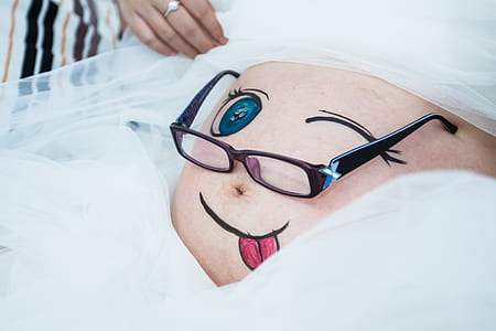 brown eyeglasses on belly thumbnail