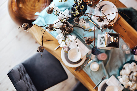 Fancy restaurant dinner table decorated with quail eggs and feathers thumbnail