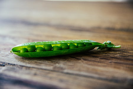 green peas on brown wooden surface thumbnail