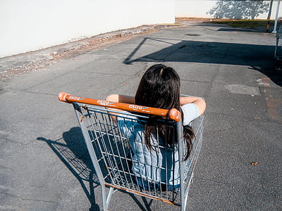 girl sitting in gray shopping cart thumbnail
