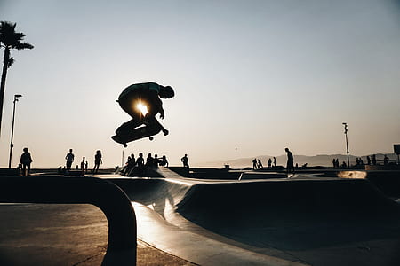 silhouette photography of person playing skateboard thumbnail