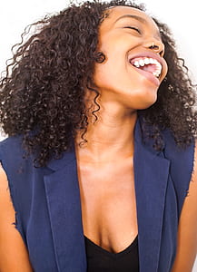 woman wearing blue sleeveless blouse while smiling thumbnail