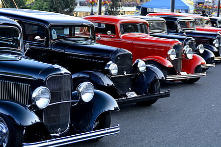 classic red and black vehicles parked in lot at daytime thumbnail