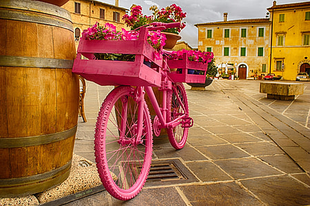 pink bicycle park beside wooden barrel thumbnail