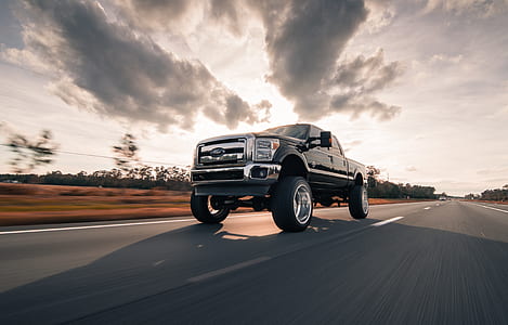 black pickup truck traveling thumbnail