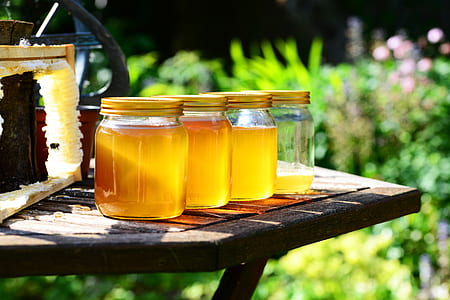 four clear glass mason jars on table thumbnail