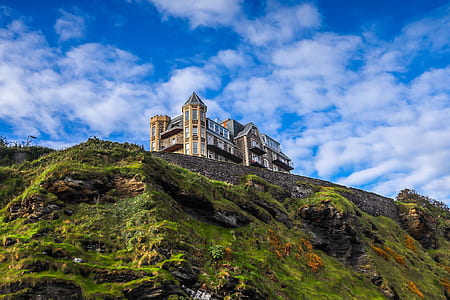 mansion house on mountain under cloudy sky thumbnail