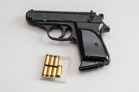 black semi-automatic pistol with brass bullets thumbnail