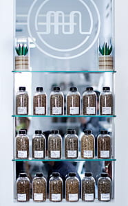 Clear Glass Containers On Glass Shelves thumbnail