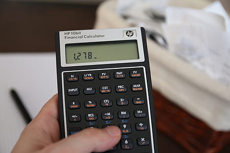 person holding black and gray HP Financial calculator at 1,278 thumbnail