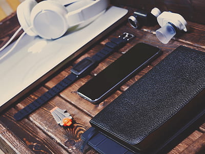 space gray iPhone 6 beside watch on wooden surface thumbnail