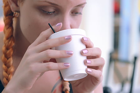 woman drinking on white disposable cup thumbnail