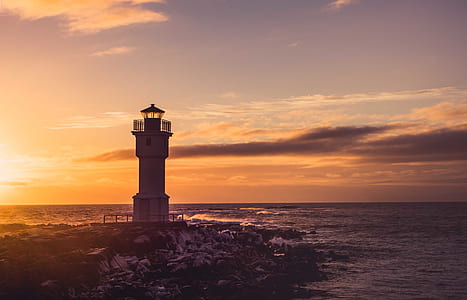 white and black lighthouse near tree thumbnail