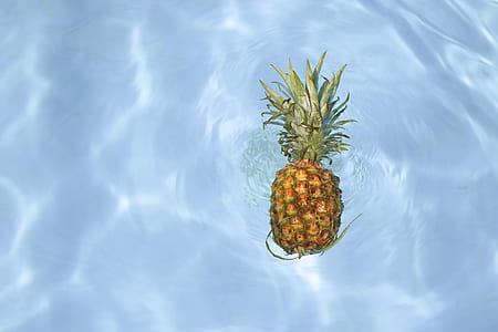 pineapple floating on body of water thumbnail