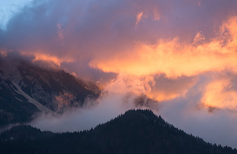mountains under gray clouds during sunset thumbnail