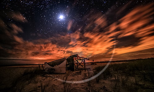 gray stand under orange clouds during golden hour thumbnail