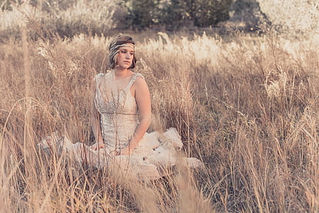 woman sitting at grass field thumbnail