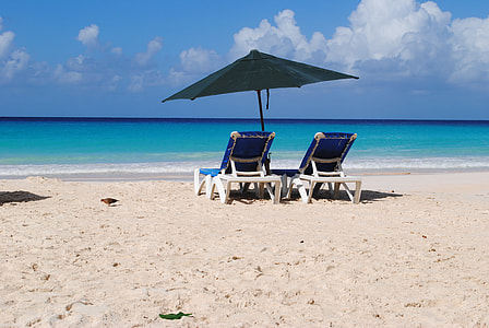 two blue-and-white lounge on beachfront during daytime thumbnail