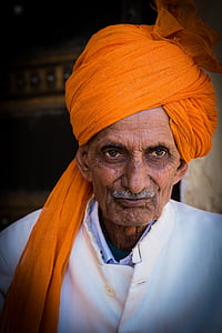 man wearing orange turban and white sherwani coat thumbnail