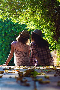 selective focus photo of two person sitting on staircase thumbnail