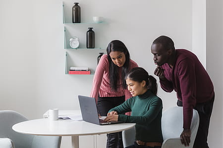 Friends Look On Laptop In Office Photo thumbnail