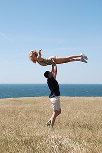 man in black shirt and white shorts lifting woman in brown leopard print mini dress thumbnail