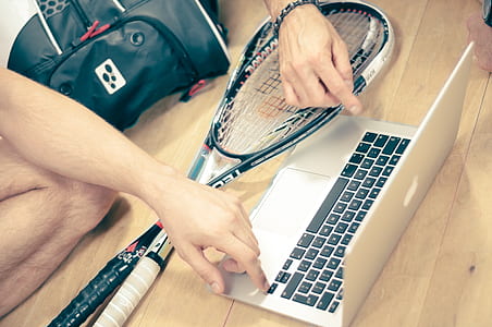 two people pointing on MacBook Pro on beige wooden surface thumbnail