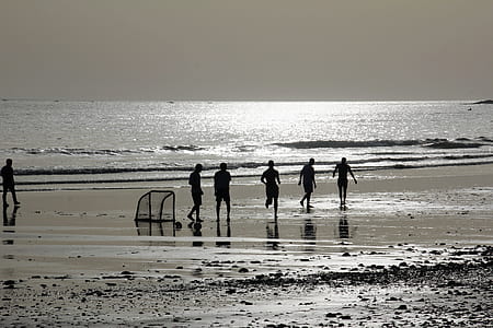 silhouette of people walking towards sea thumbnail