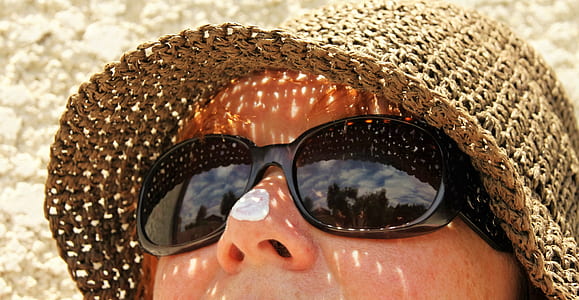 woman wearing black sunglasses and brown hat thumbnail