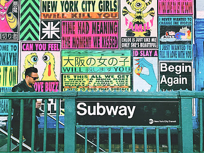 man walking near billboards thumbnail