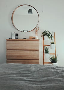 brown wooden dresser with mirror beside brown wooden flower pot ladder rack thumbnail