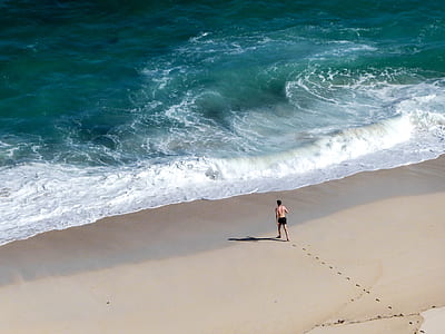 man standing beside shoreline thumbnail